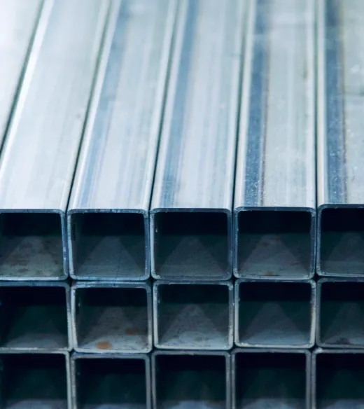 Stack of square metal tubes ready for fabrication.